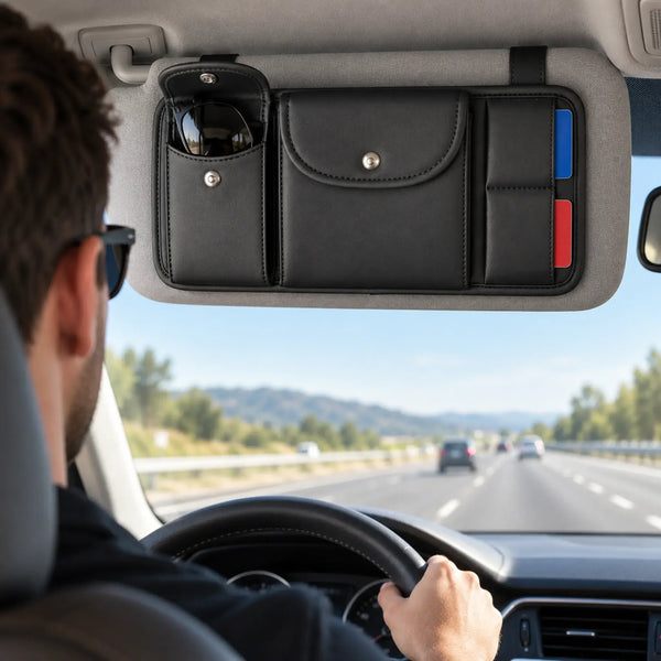 Driver on an open highway with black organizer mounted neatly to the grey sun visor above