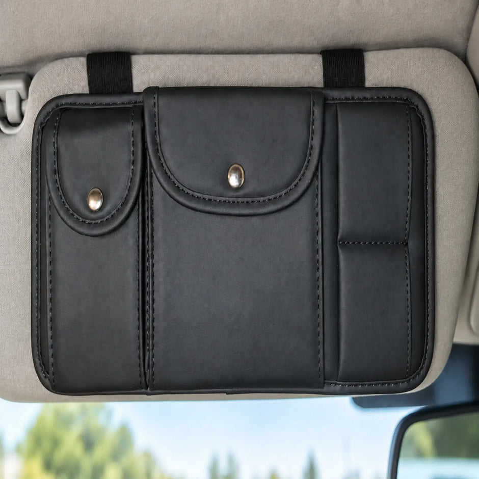 Black faux-leather organizer mounted horizontally on a grey vehicle sun visor