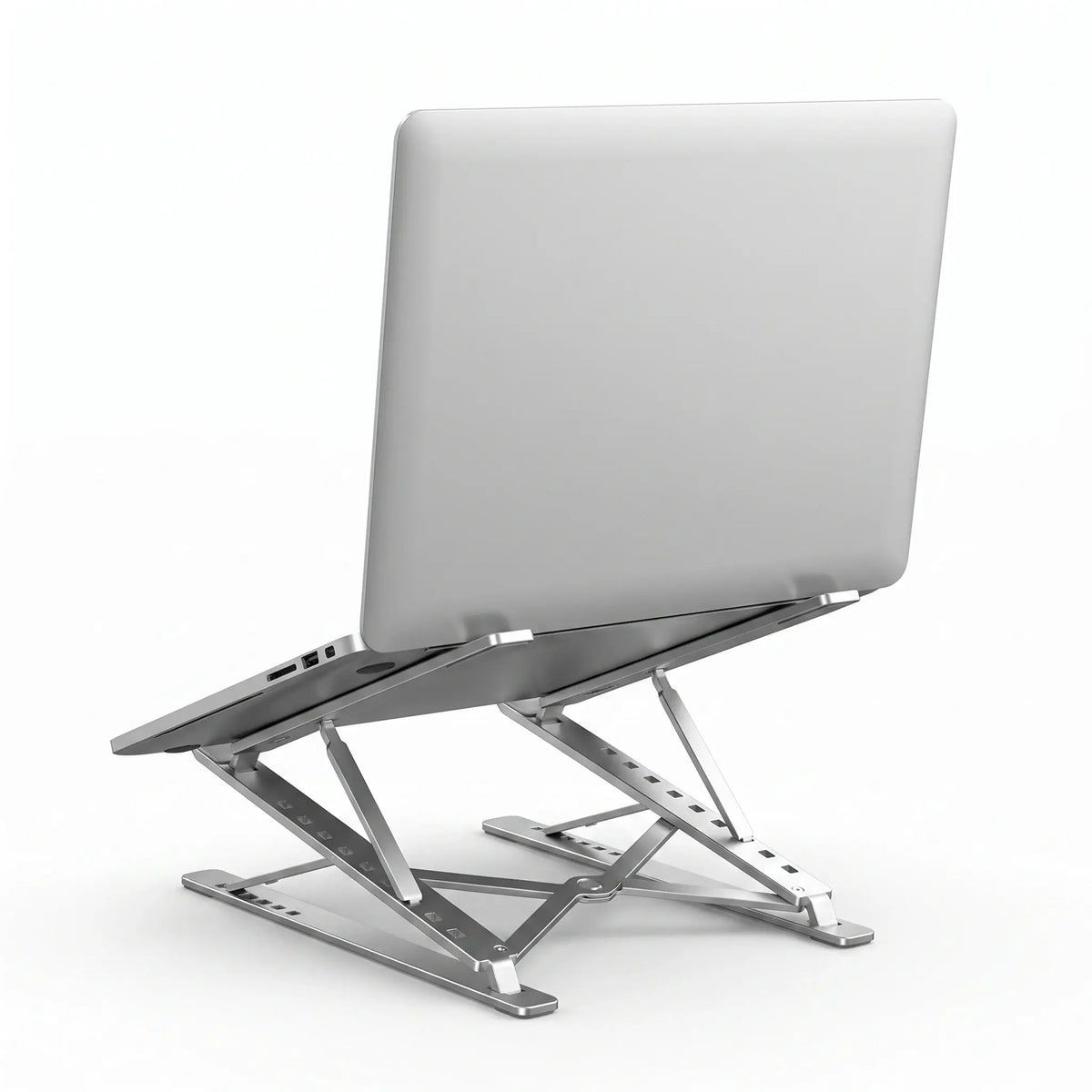 Laptop supported at an elevated angle on a foldable aluminum laptop stand.
