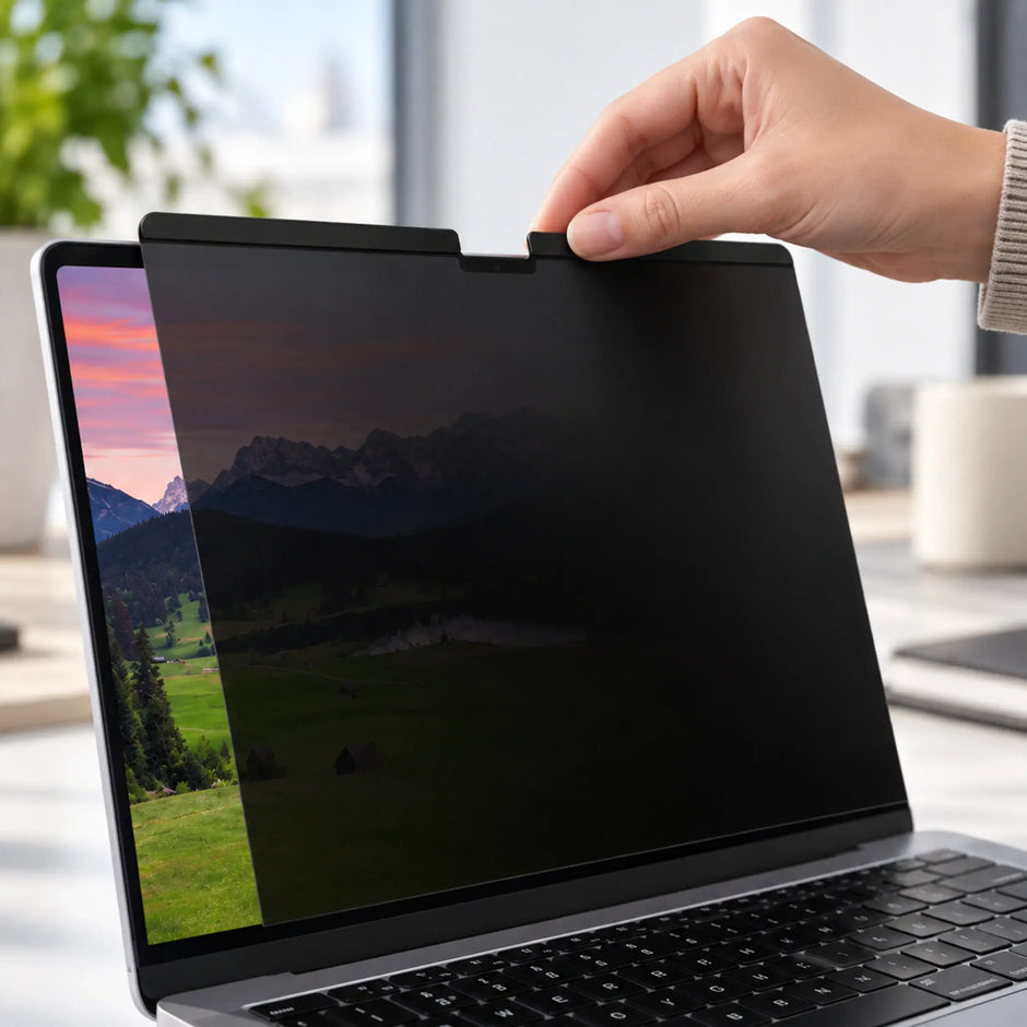 Close-up of magnetic privacy screen attaching to the upper edge of a MacBook display