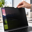 Close-up of magnetic privacy screen attaching to the upper edge of a MacBook display