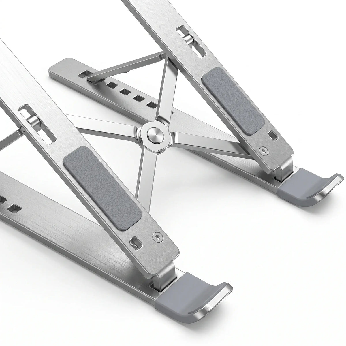Close-up of silicone pads, retaining hooks, hinges, and aluminum construction on laptop stand.