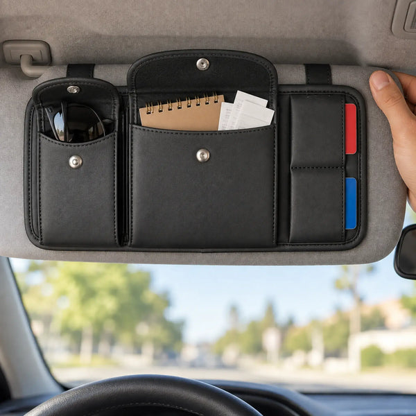 Sun visor organizer holding sunglasses, notebook, receipts, and cards inside a bright car interior