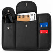 Open black sun visor organizer holding sunglasses, a small notebook, papers, and two cards