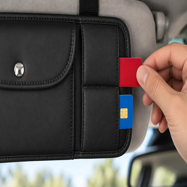 Close-up of hand accessing two stacked horizontal card sleeves on black sun visor organizer